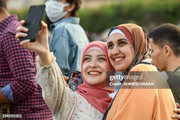 Worshipppers take a selfie as Muslims gather on the first day of Eid al-Fitr, which marks the end of the holy fasting month of Ramadan in the...