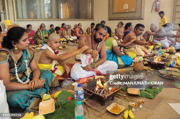 Young Hindu lad belonging to the Brahmin community perform rituals with his family during a mass Upanayana the sacred thread ceremony, usually...