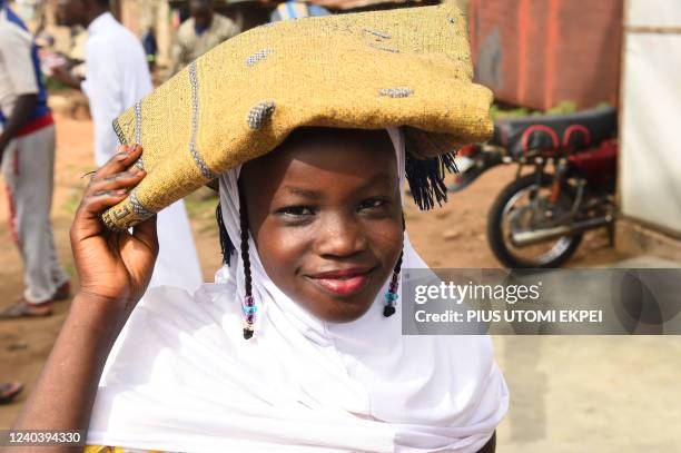 Young girl carries prayer mat arrives to pray at Kara Mosque, Ibafo, Ogun State in southwest Nigeria, on May 2, 2022. - Muslims in Nigeria joined...