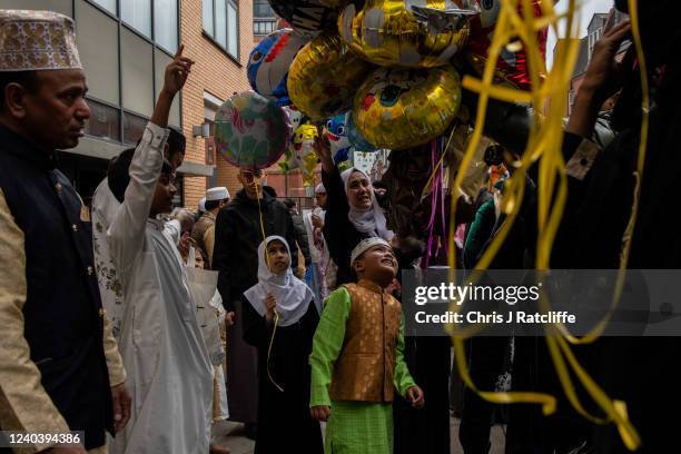 Children choose balloons outside the East London Mosque after morning prayers during Eid Al-Fitr celebrations on May 2, 2022 in London, England. Eid...