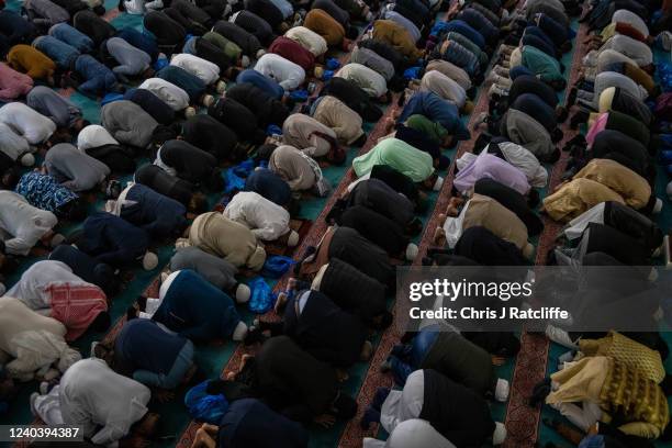 Men take part in morning prayers during Eid Al-Fitr celebrations at East London Mosque on May 2, 2022 in London, England. Eid al-Fitr comes at the...