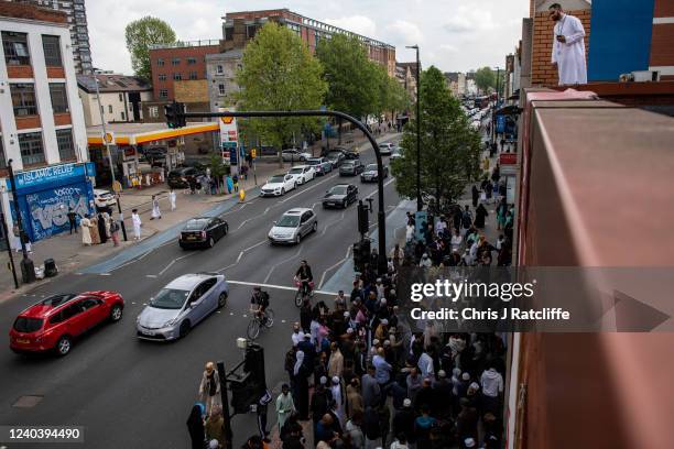 Men queue to enter the East London Mosque for morning prayers during Eid Al-Fitr celebrations on May 2, 2022 in London, England. Eid al-Fitr comes at...