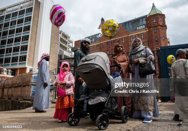 Family gathers outside the East London Mosque after morning prayers during Eid Al-Fitr celebrations on May 2, 2022 in London, England. Eid al-Fitr...