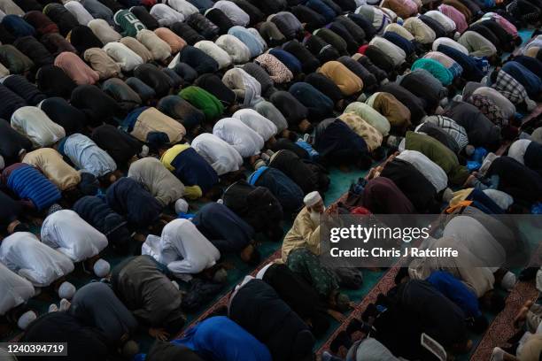 Men take part in morning prayers during Eid Al-Fitr celebrations at East London Mosque on May 2, 2022 in London, England. Eid al-Fitr comes at the...