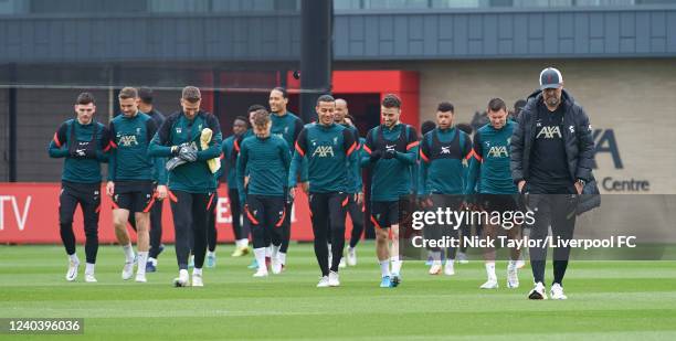 Manager Jurgen Klopp of Liverpool leads hi players on to the training pitch during a training session at AXA Training Centre on May 2, 2022 in...