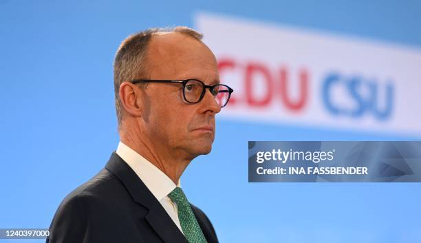 Leader of Germany's conservative Christian Democratic Union party Friedrich Merz reacts on stage during a closed meeting of the conservative sister...