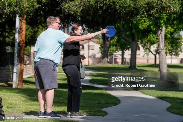 Azusa, CA, Monday, April 25, 2022 - Eric Virnala gives a pointer to his daughter, Janelle as they play the Northside Park Disc Golf Course.