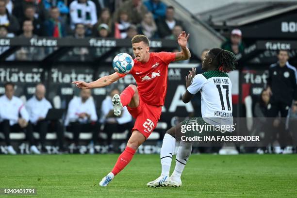 Leipzig's Spanish midfielder Dani Olmo and Moenchengladbach's French midfielder Kouadio Kone vie for the ball during the German first division...