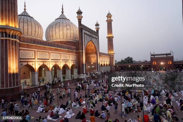 Muslims eat their iftar meals on the last day of the holy fasting month of Ramadan, ahead of celebrating Eid-al-Fitr festival, at the Jama Masjid in...