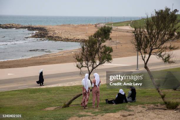 Muslims girls enjoy during the Eid al-Fitr holiday, at the mediterranean beachfront of the mixed Arab Jewish city of Jaffa near Tel Aviv on May 2,...