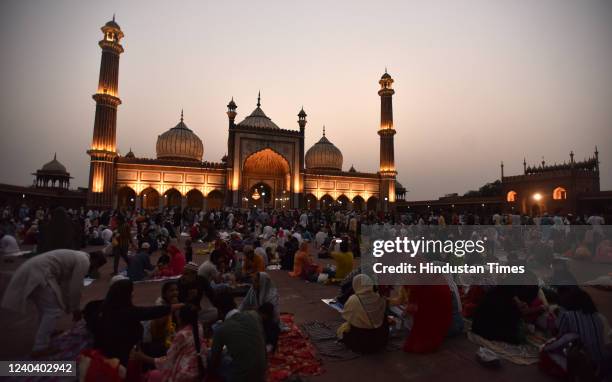 Muslims assemble for their Roza iftar in front of Illuminated Jama Masjid on the eve of Eid-ul-Fitr festival on May 2, 2022 in New Delhi, India....