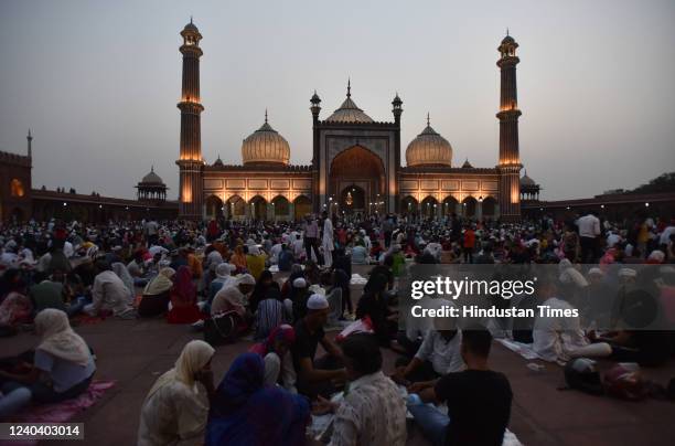 Muslims assemble for their Roza iftar in front of Illuminated Jama Masjid on the eve of Eid-ul-Fitr festival on May 2, 2022 in New Delhi, India....