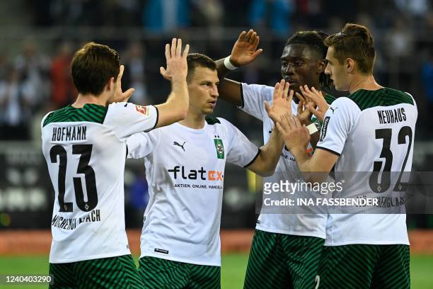 Moenchengladbach's German midfielder Jonas Hofmann celebrates scoring the 2-1 goal with Moenchengladbach's Austrian defender Stefan Lainer,...