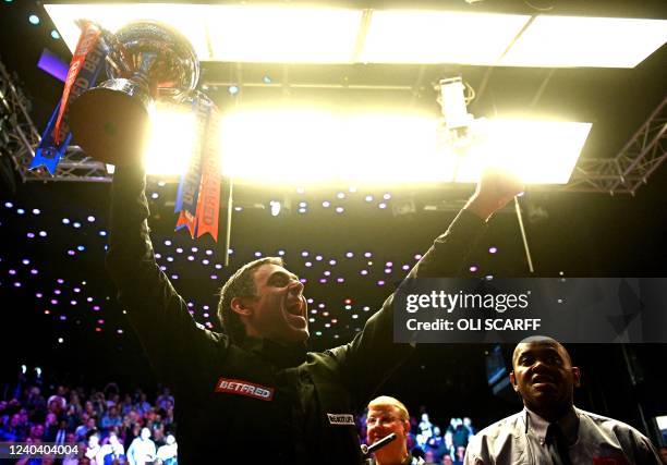 England's Ronnie O'Sullivan poses with the trophy after his victory over England's Judd Trump in the World Championship Snooker final at The Crucible...