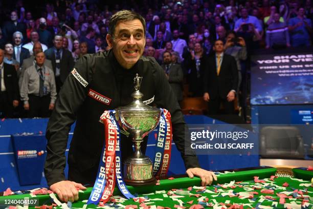 England's Ronnie O'Sullivan poses with the trophy after his victory over England's Judd Trump in the World Championship Snooker final at The Crucible...