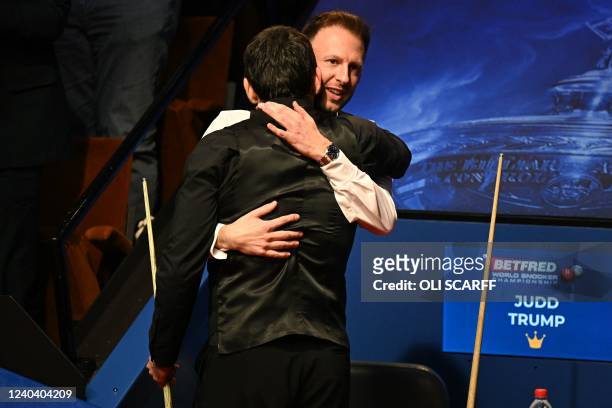 England's Ronnie O'Sullivan embraces England's Judd Trump after his win over Trump in the World Championship Snooker final at The Crucible in...