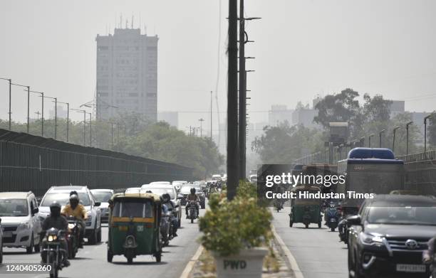 People on the vehicle arrive at Vikas Marg during a hot summer afternoon as mercury level rises at the capital on May 2, 2022 in New Delhi, India....