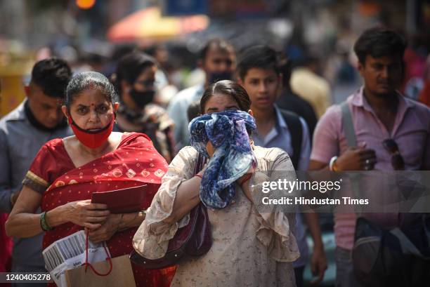 Commuters out in Karol Bagh on a hot summer day on May 2, 2022 in New Delhi, India. Heatwave conditions are expected to continue over Delhi and...