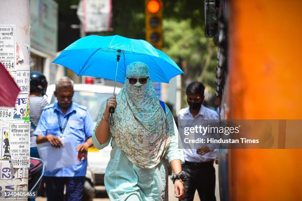 Commuters out in Karol Bagh on a hot summer day on May 2, 2022 in New Delhi, India. Heatwave conditions are expected to continue over Delhi and...