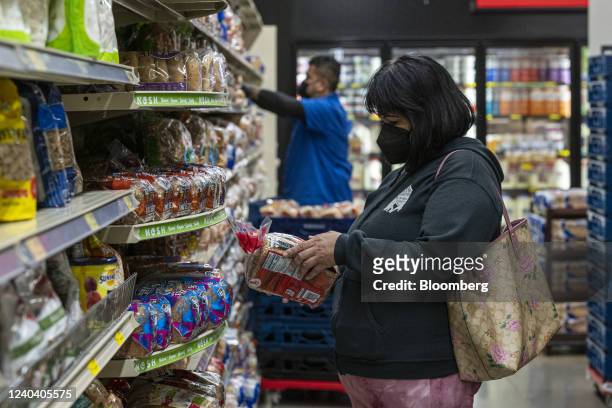 Shopper checks a loaf of bread inside a grocery store in San Francisco, California, U.S., on Monday, May 2, 2022. U.S. Inflation-adjusted consumer...