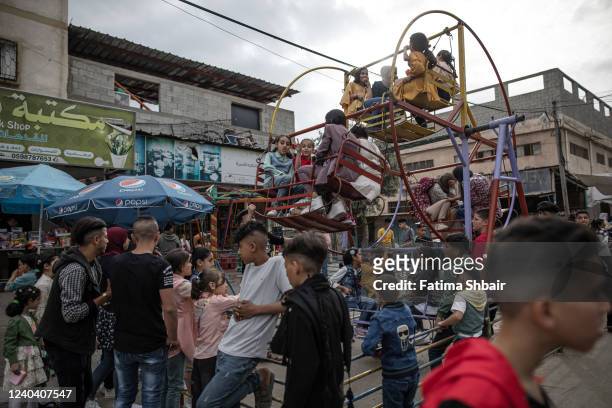 Palestinians enjoy their time on the first day of Eid al-Fitr in Jabalia refugee camp in the northern Gaza Strip on May 2, 2022 in Gaza City, Gaza....