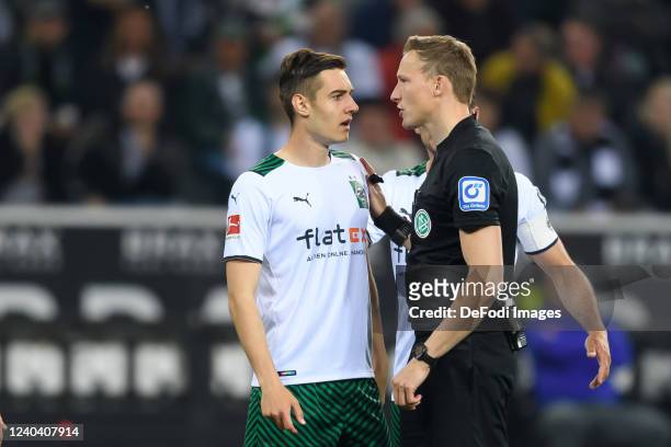 Florian Neuhaus of Borussia Moenchengladbach and referee Martin Petersen discusses during the Bundesliga match between Borussia Mönchengladbach and...