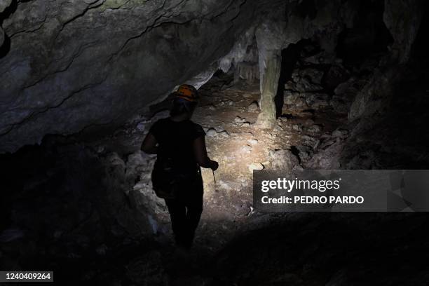 Activist and speleologist Tania Ramirez explores the cave known as Dama Blanca in the construction site of Section 5 South of the Mayan Train between...