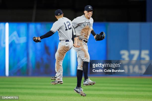 Aaron Judge and Isiah Kiner-Falefa of the New York Yankees celebrate their 3-2 victory against the Toronto Blue Jays at Rogers Centre on May 2, 2022...