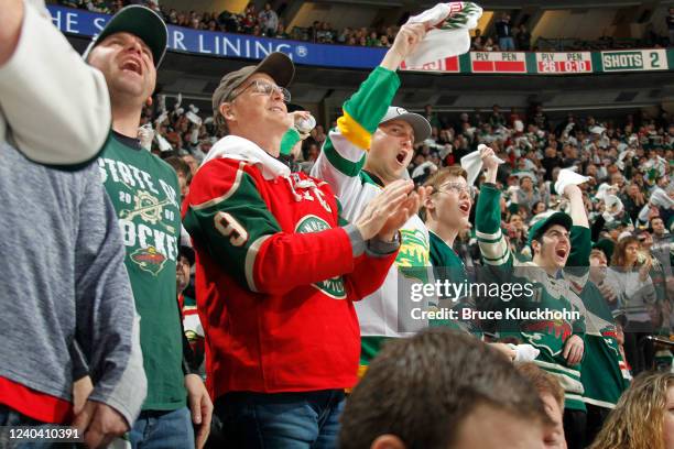 Minnesota Wild fans cheer on their team against the St. Louis Blues in Game One of the First Round of the 2022 Stanley Cup Playoffs at the Xcel...