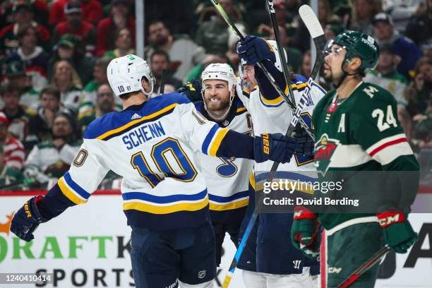 The St. Louis Blues celebrate a power play goal by David Perron as Matt Dumba of the Minnesota Wild reacts in the first period in Game One of the...