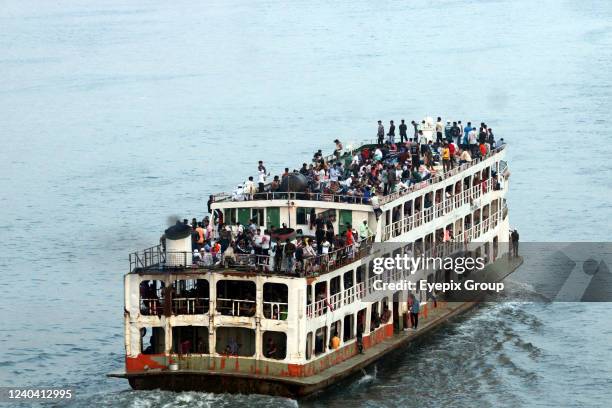 Ferries packed with travelers are seen at Sadarghat Terminal. As Eid-ul-Fitr Festival is drawing near, thousands of Bangladeshi capital dwellers have...