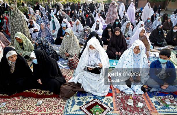 Muslim devotees offer Eid al-Fitr morning prayer in the Iranian city of Shahr-e-Rey , south of the capital Tehran, on May 3, 2022. - Muslims across...