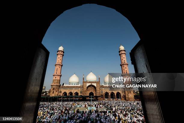 Muslim devotees gather to offer a special morning prayer to start the Eid al-Fitr festival, which marks the end of their holy fasting month of...