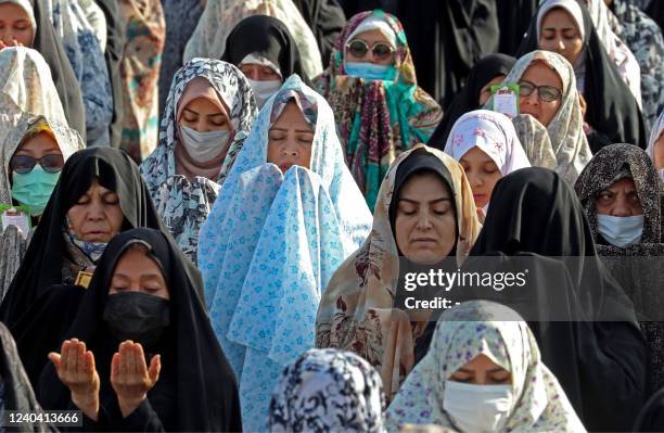 Muslim devotees offer Eid al-Fitr morning prayer in the Iranian city of Shahr-e-Rey , south of the capital Tehran, on May 3, 2022. - Muslims across...