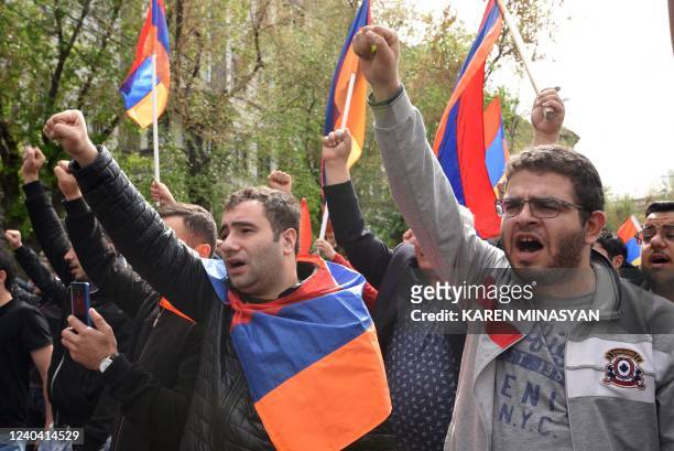 Demonstrators shout slogans as they attend an opposition rally held to protest against Karabakh concession in Yerevan on May 3, 2022. -...