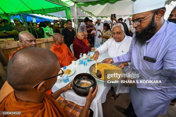 Buddhist monks take part in the Eid al-Fitr festival celebrations under a tent installed near the office of Sri Lanka's President Gotabaya Rajapaksa...
