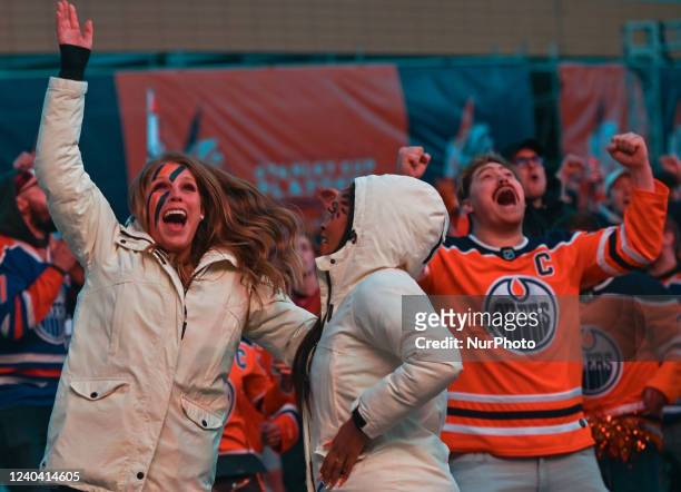Oilers fans celebrate after McDavid scores in the first match of the playoffs between Edmonton Oillers vs Los Angeles Kings outside Rogers Place, in...