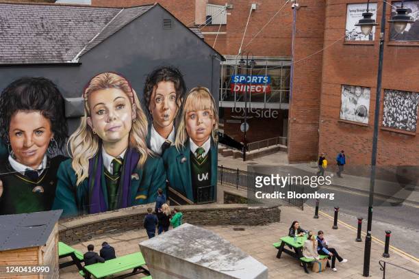 Mural depicting characters from TV comedy show "Derry Girls" on the facade of a building in the city center of Derry, Northern Ireland, U.K., on...