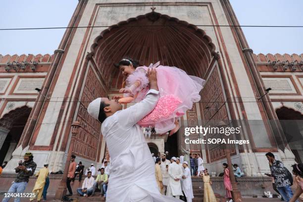 Muslim father plays with his daughter after offering Eid al-Fitr special prayers at Jama Masjid in the Old quarters. Muslims around the world...