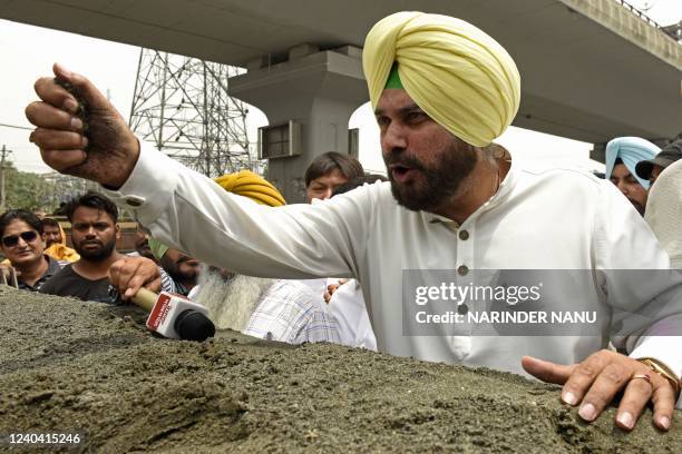 India's Congress party leader Navjot Singh Sidhu addresses the media during his visit at the retail construction material market in Amritsar on May...