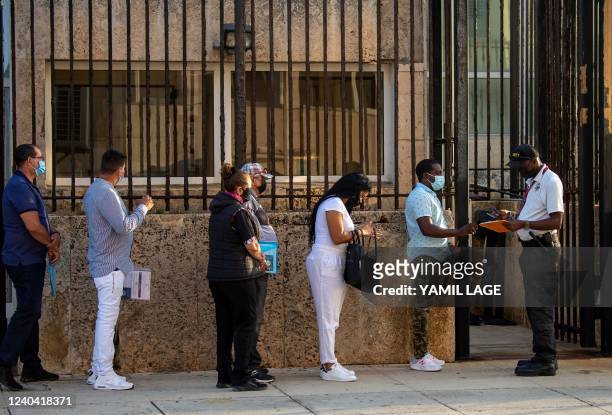 People queue at the US embassy in Havana on May 3 as the consulate resumed issuing some immigrant visa services which have been suspended since 2017...
