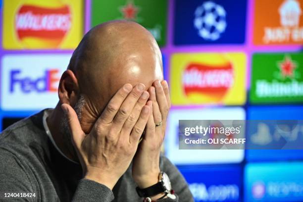 Manchester City's Spanish manager Pep Guardiola reacts as he speaks during a press conference at the Manchester City training ground, in Manchester,...