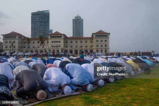 Sri Lankan Muslims devotees offer Eid prayers on the first day of the Eid al-Fitr festival at the Galle Face esplanade in Colombo on May 3, 2022. The...