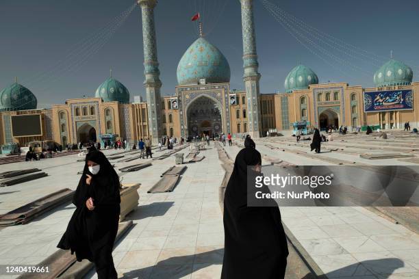Two Shi'ite Muslim women walk at Jamkaran holy mosque after the Eid-al-Fitr mass prayers ceremony in Qom, 145 kilometers south of Tehran, two years...