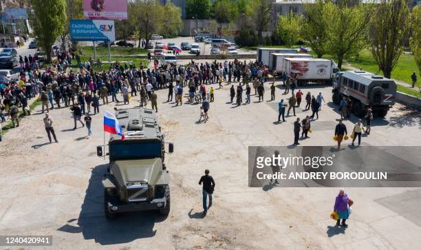 An aerial view taken on April 30, 2022 shows local people and refugees from Donetsk region lining up for humanitarian aid distributed from Russian...