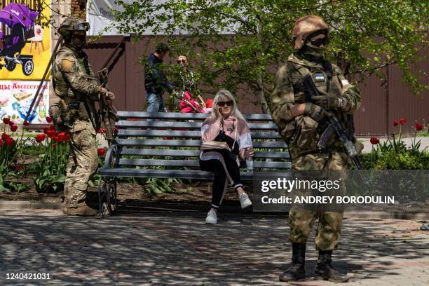 Russian servicemen patrol a street in Berdyansk on April 30, 2022. *EDITOR'S NOTE: This picture was taken during a media trip organised by the...