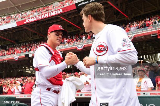 Tyler Stephenson of the Cincinnati Reds shakes hands with Joe Burrow of the Cincinnati Bengals before the game between the Cleveland Guardians and...