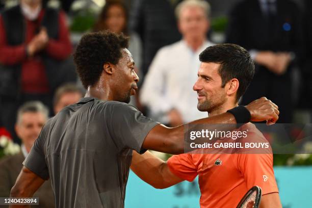 Serbia's Novak Djokovic and France's Gael Monfils hug at the end of their 2022 ATP Tour Madrid Open tennis tournament singles match at the Caja...