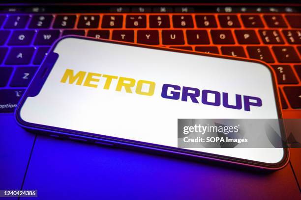 In this photo illustration, a Metro Group logo is displayed on the screen of a smartphone.