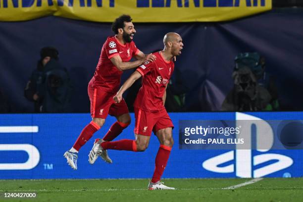 Liverpool's Brazilian midfielder Fabinho celebrates with teammate Liverpool's Egyptian midfielder Mohamed Salah after scoring a goal during the UEFA...